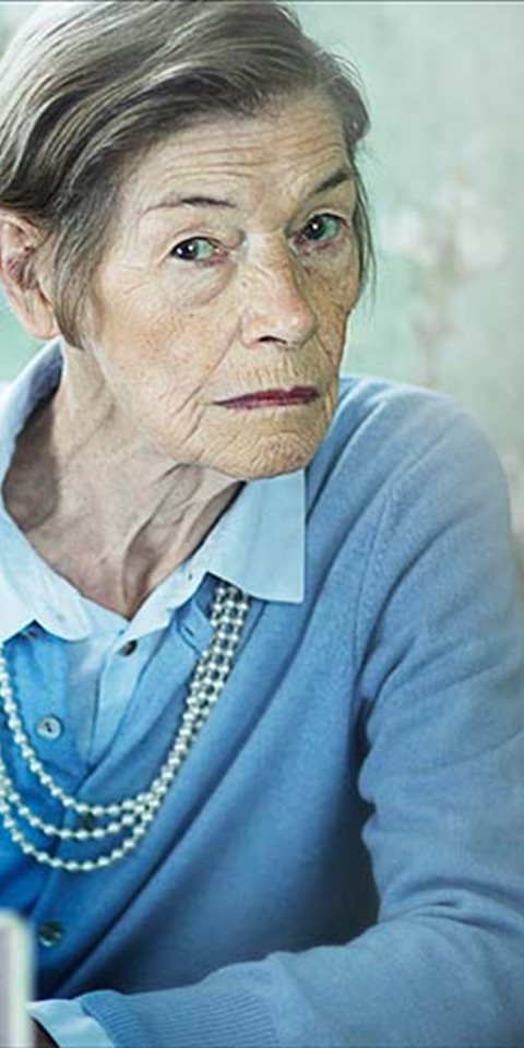 Close up shot of an actress looking at the camera.